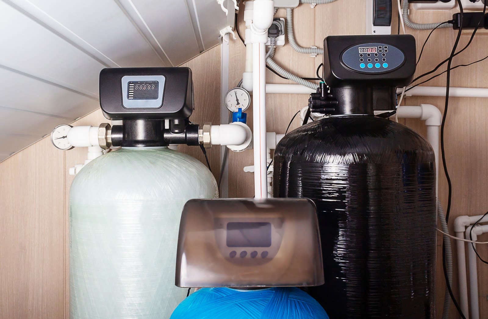 Home water treatment equipment with filtration tanks and connected plumbing